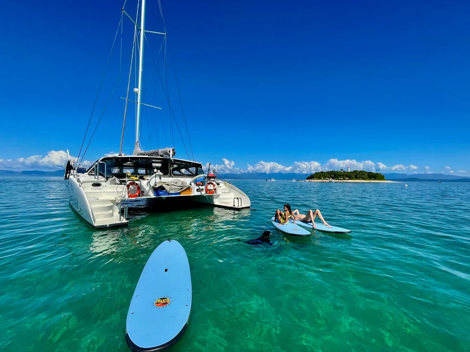 Paddleboarding beside Liquid Desire