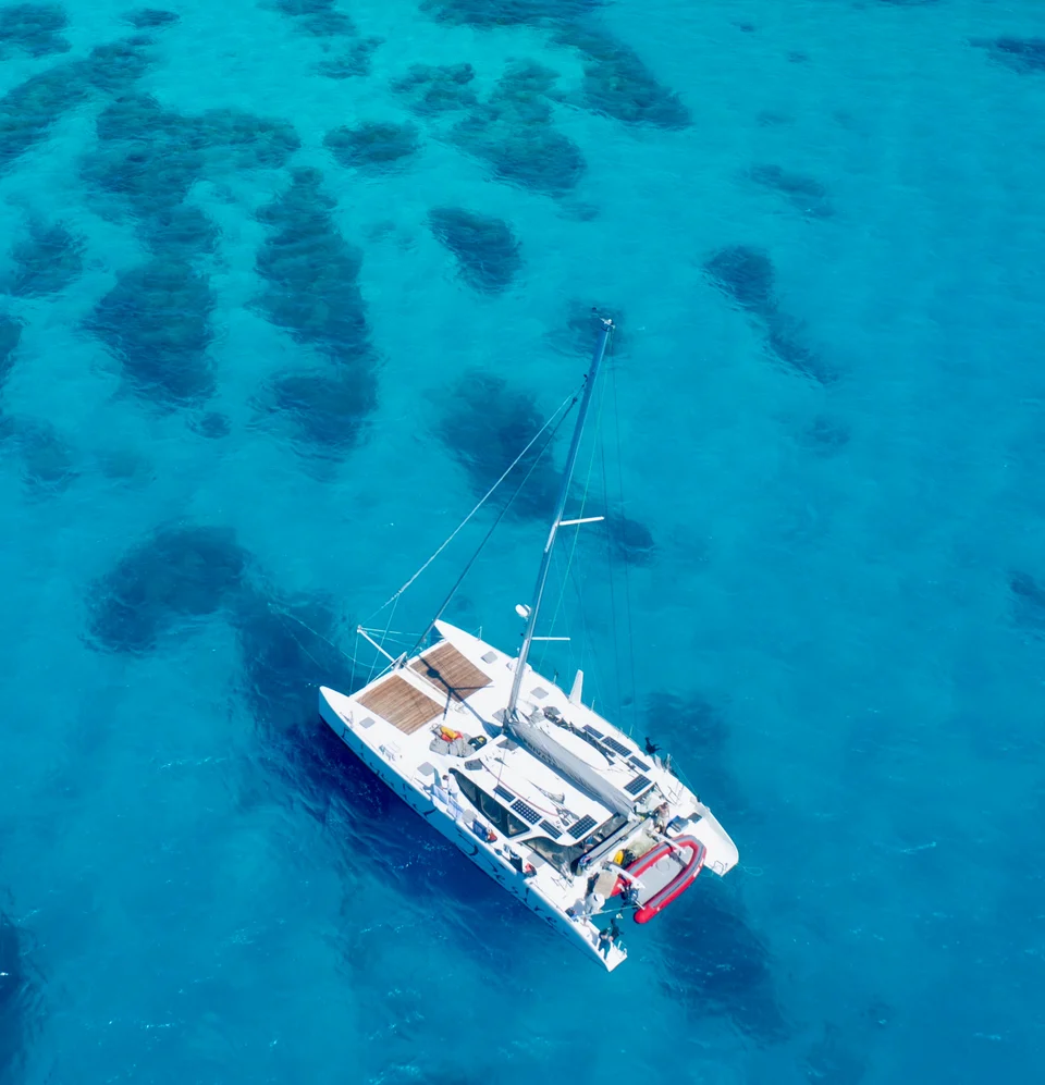 Liquid Desire anchored over coral