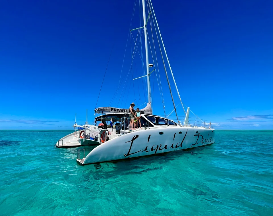 Liquid Desire at anchor on turquoise water