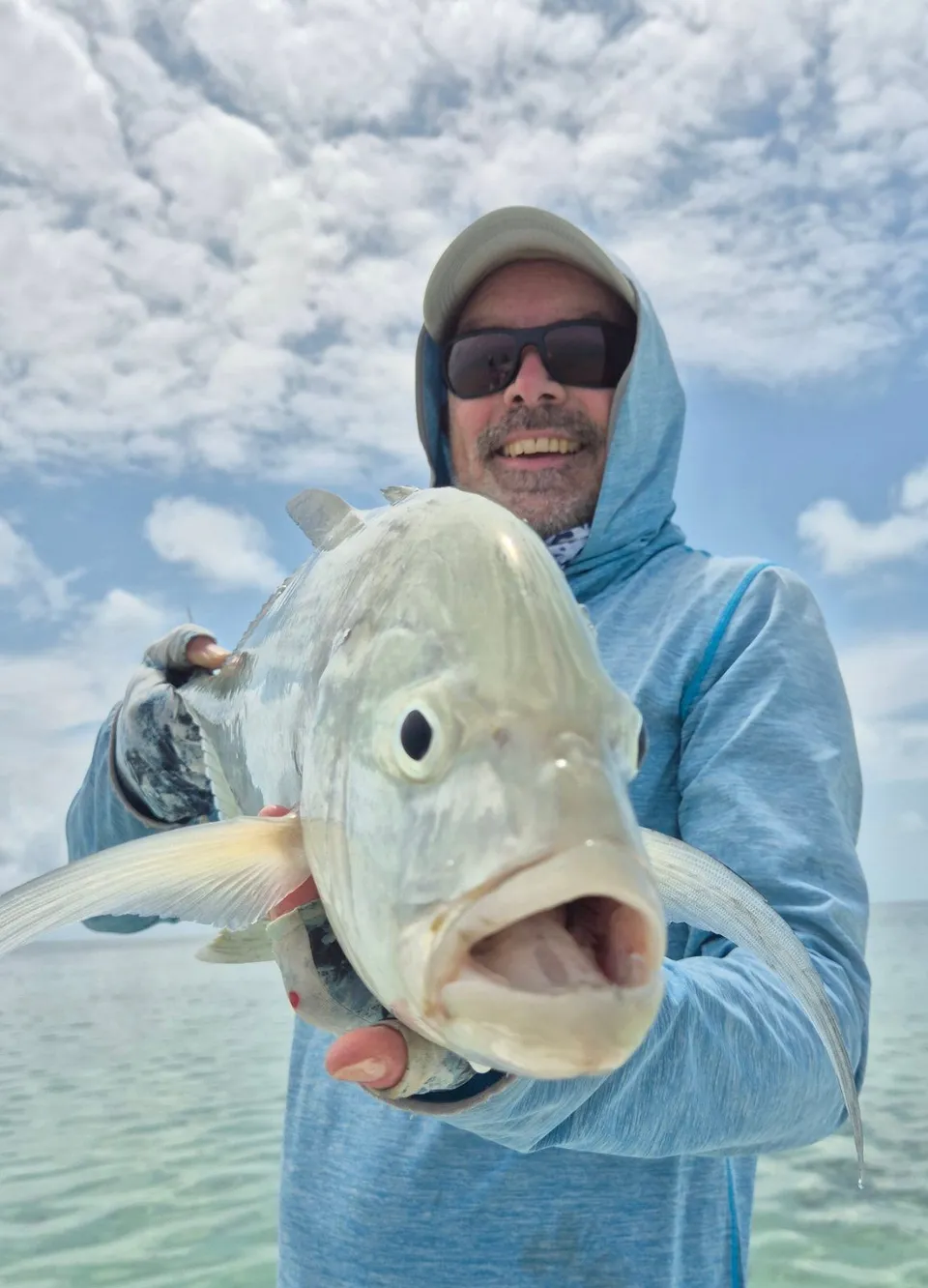 A trevally held up on the boat