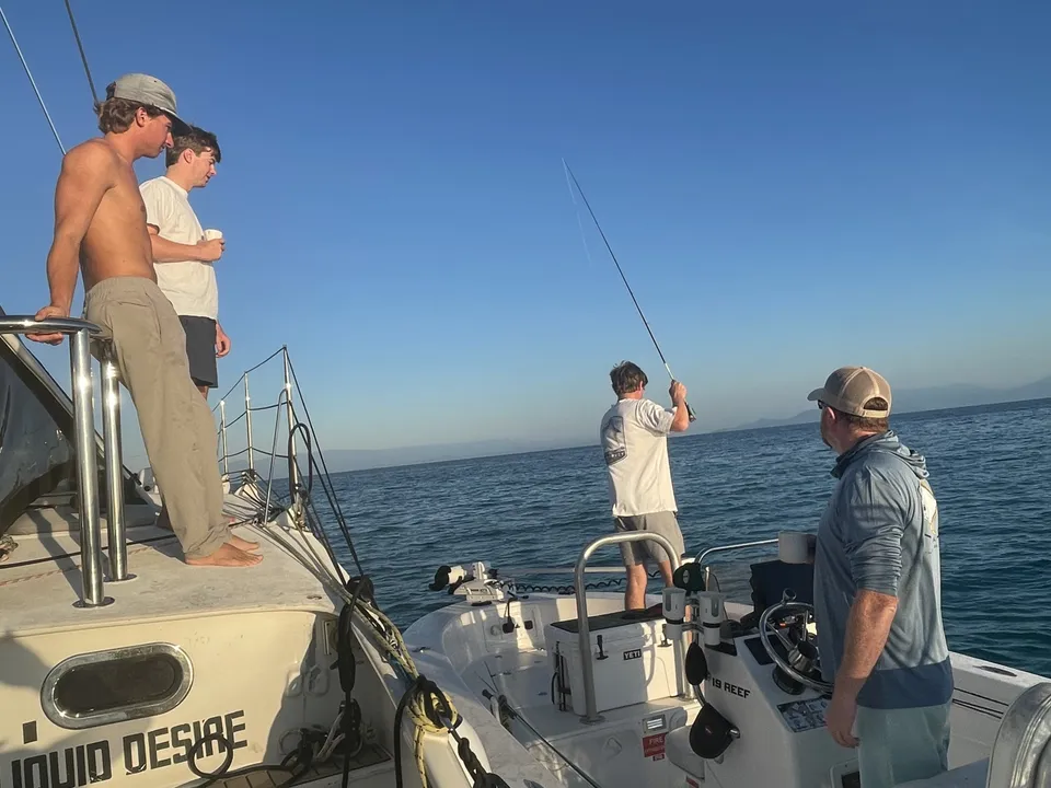 Fishing from the flats boat beside Liquid Desire