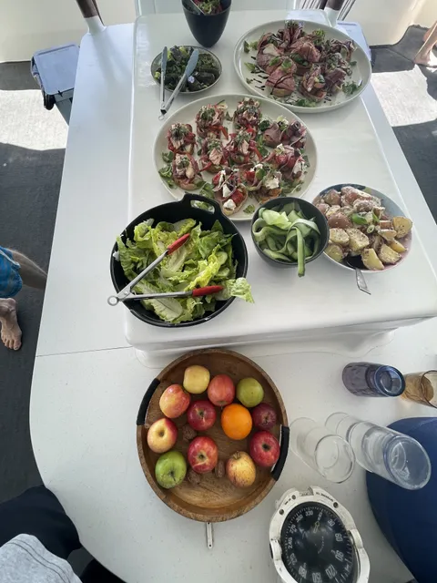 Salads and a bowl of fresh fruit