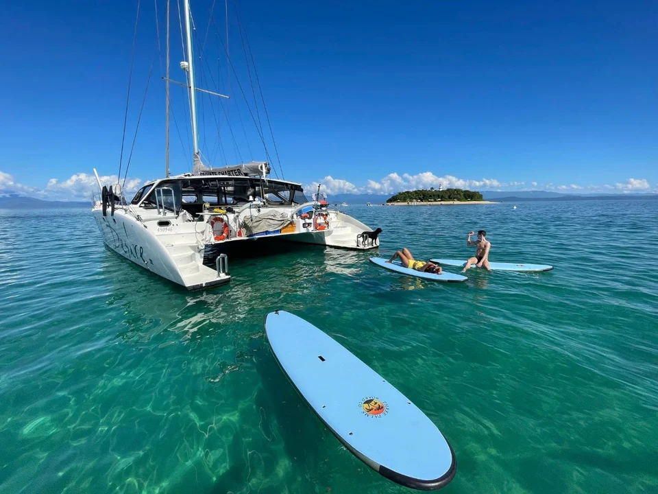 A paddleboard alongside Liquid Desire