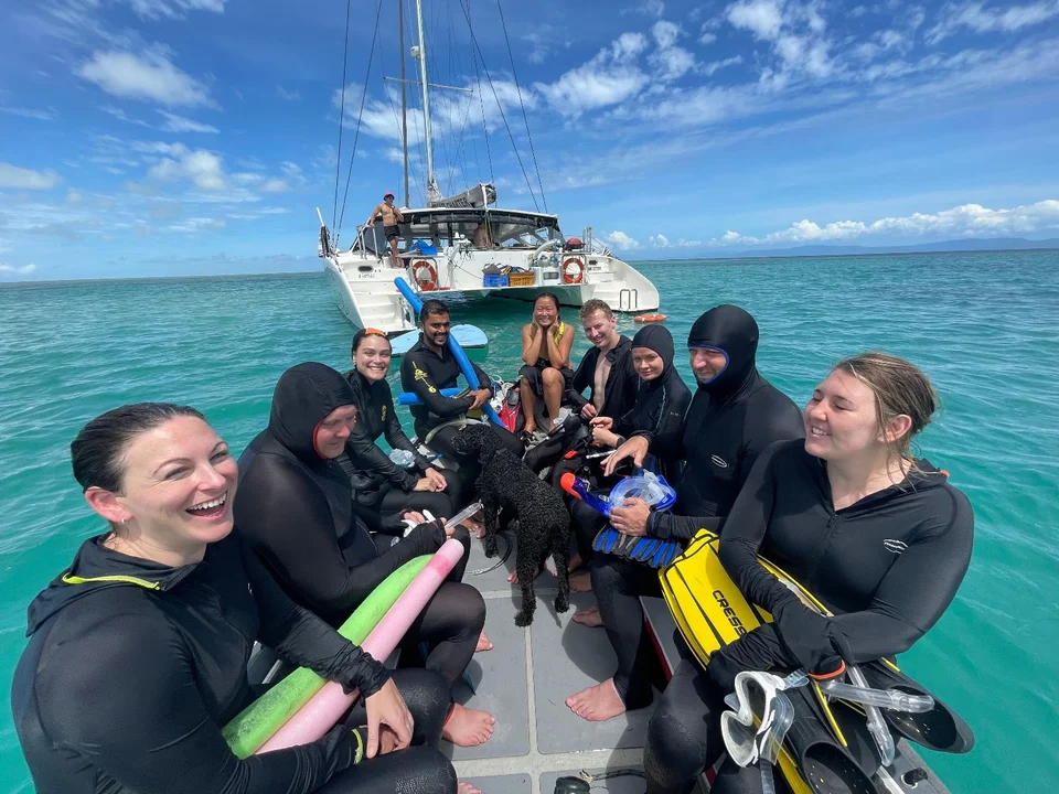 Snorkellers together beside the dinghy