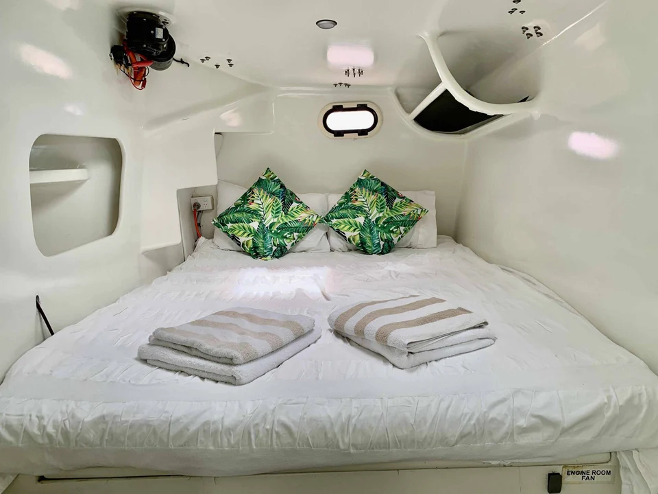 A double cabin with green cushions