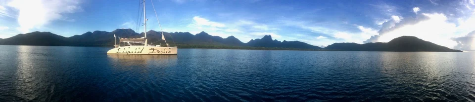 The yacht and mountainous coast, panoramic view