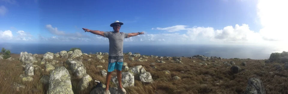 A guest standing on a rocky lookout