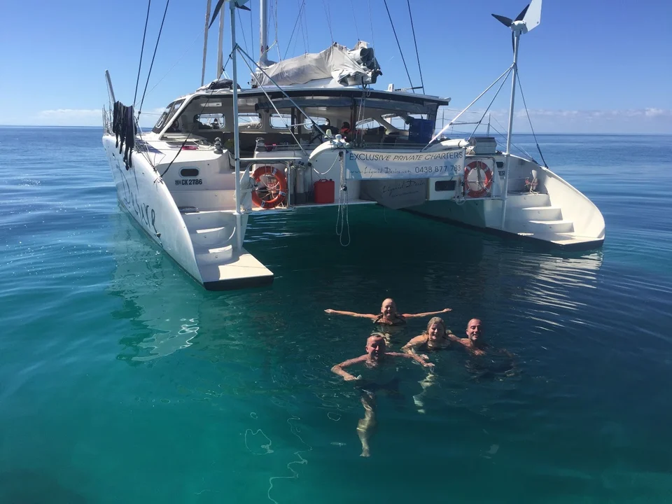 Swimming behind the yacht