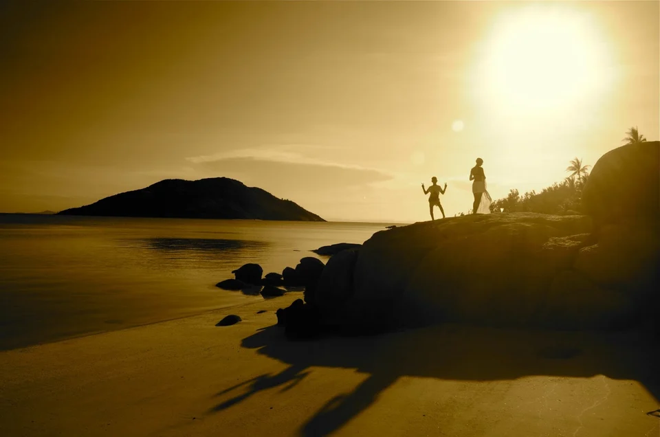 Silhouettes on the rocks at sunset