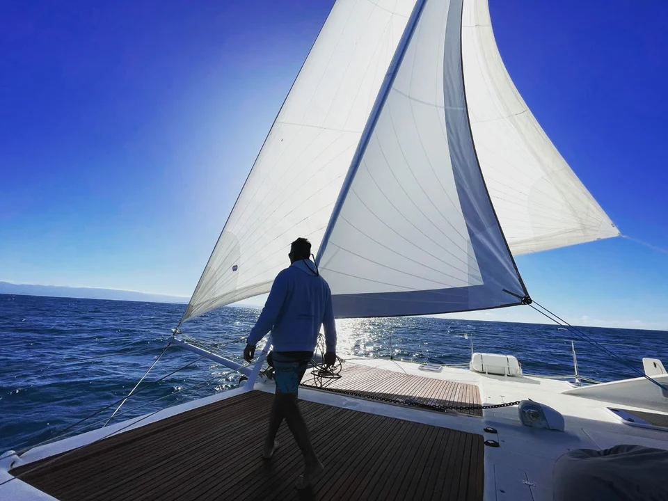 A crew member beneath the sails
