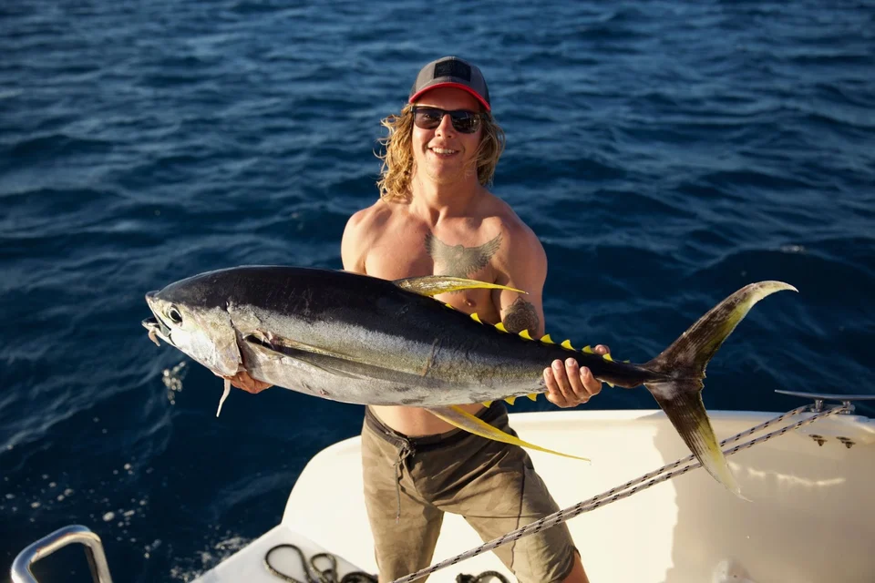 A guest holding a large fish
