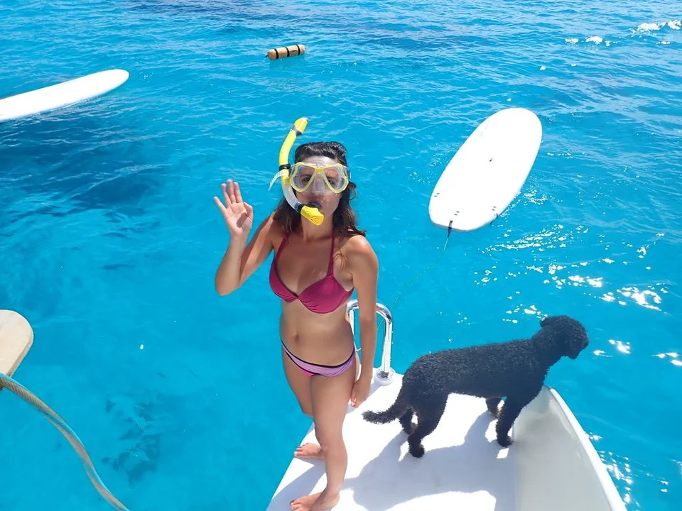 A young guest and dog by the water