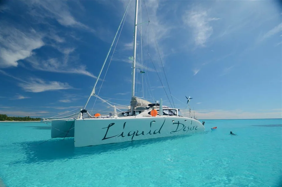 Liquid Desire anchored in a shallow lagoon