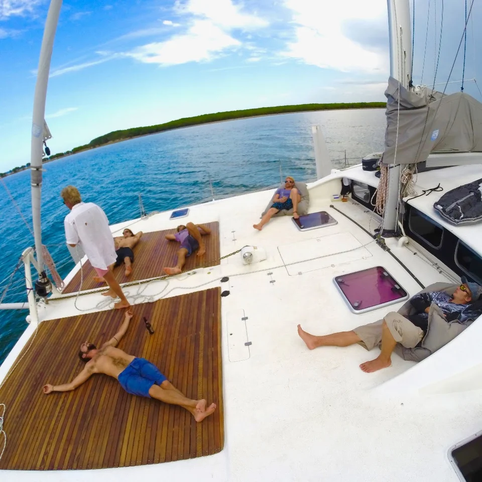 Guests on the foredeck under sail