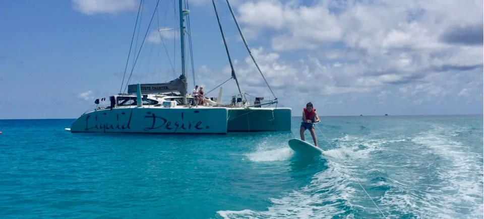 Paddleboarding beside the anchored yacht