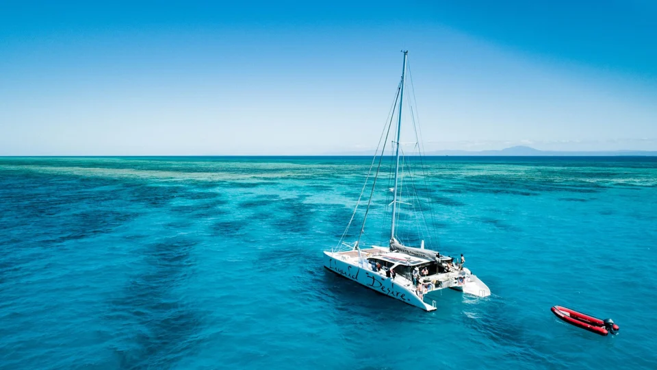 An aerial view of the yacht over the reef
