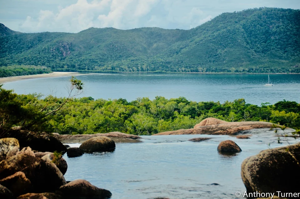Rocky shoreline and forested hills