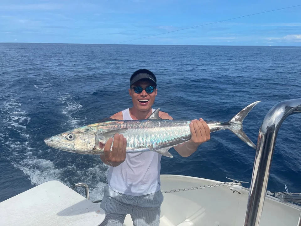 A guest holding a freshly caught fish