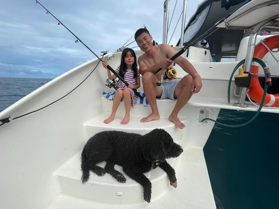 A guest and child with the dog on deck