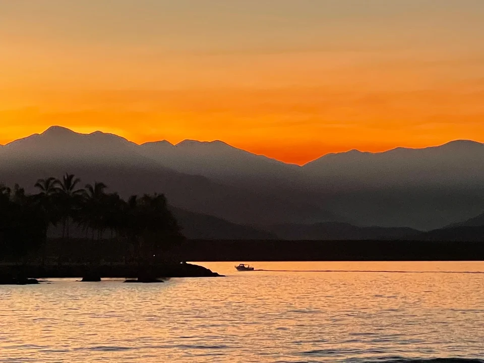 Sunset beyond the mountains and water