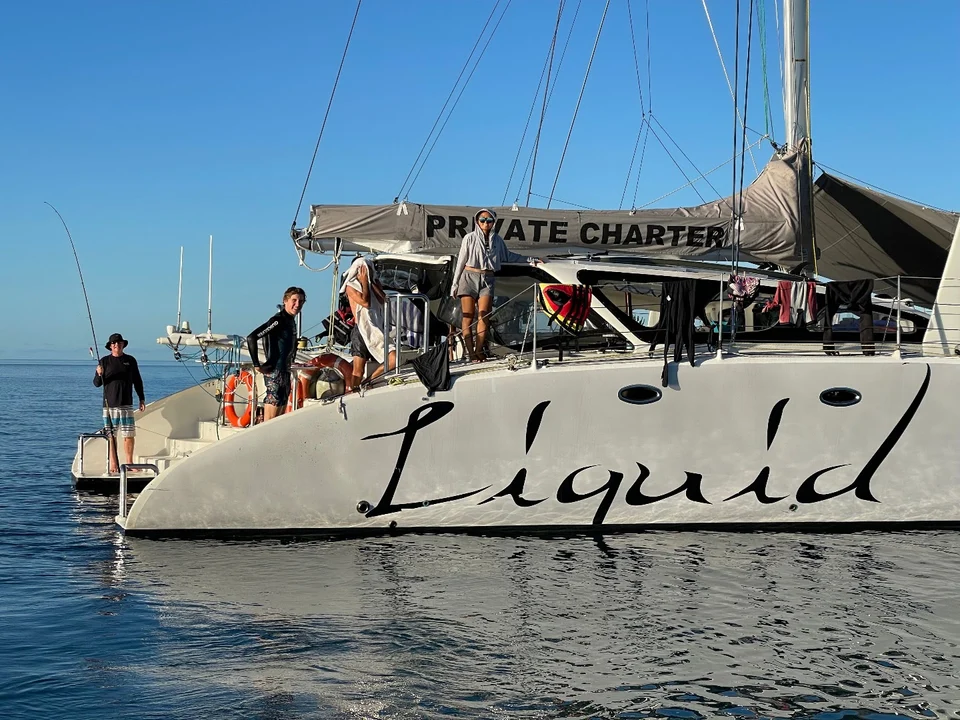 Guests on the foredeck beside the hull lettering