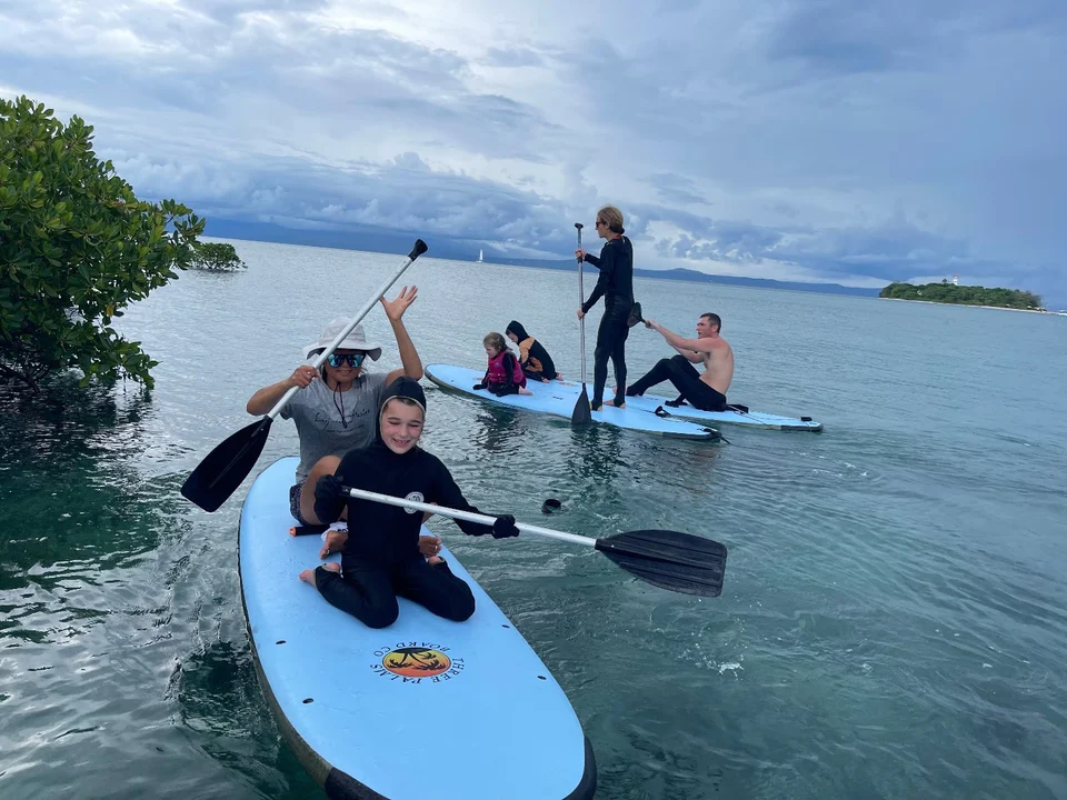 Guests paddleboarding in sheltered water