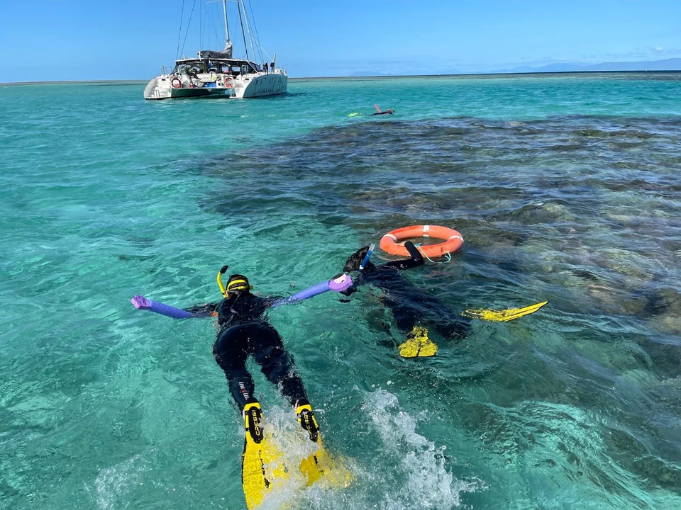 Snorkellers near the anchored yacht