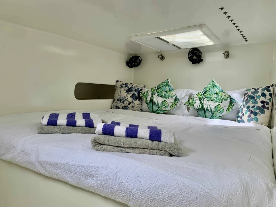 A double cabin with pillows and towels